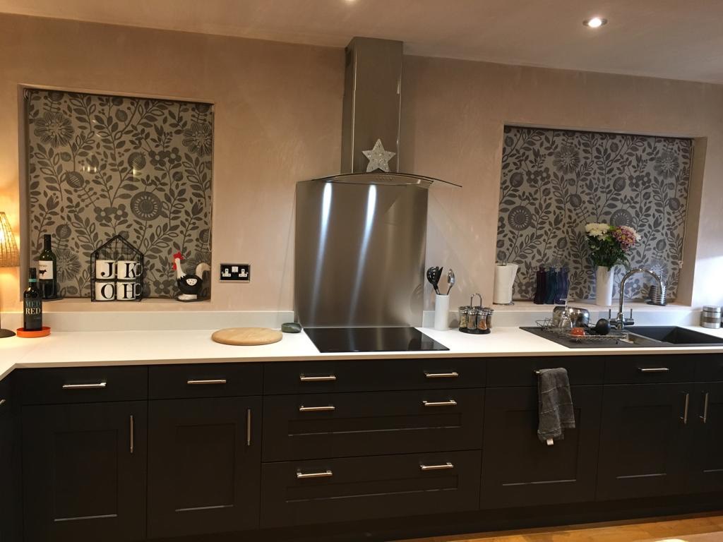 ebony fitted kitchen in Teesside with light quartz tops an da hob and extractor