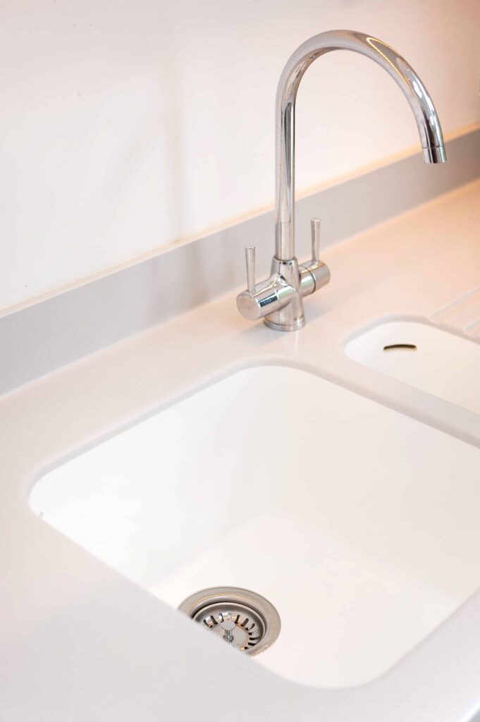 Seamless sink showing no joins with the worktop and chrome tap, Shedding Light,